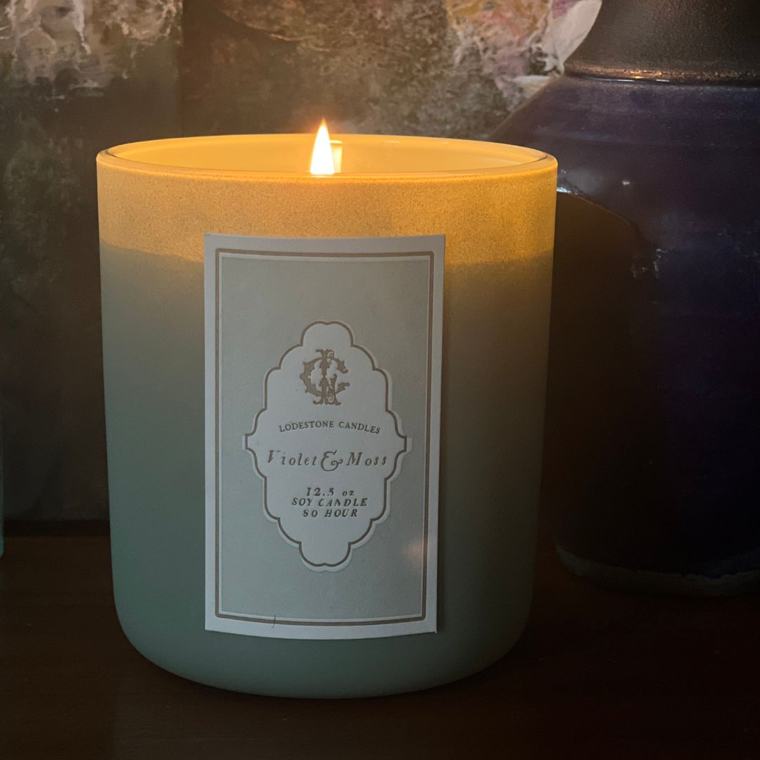 Lodestone Candles Violet & Moss candle with green galbanum, clove, orange, patchouli, sandalwood, pinion, and a woody amber, cedarwood, and tonka base.