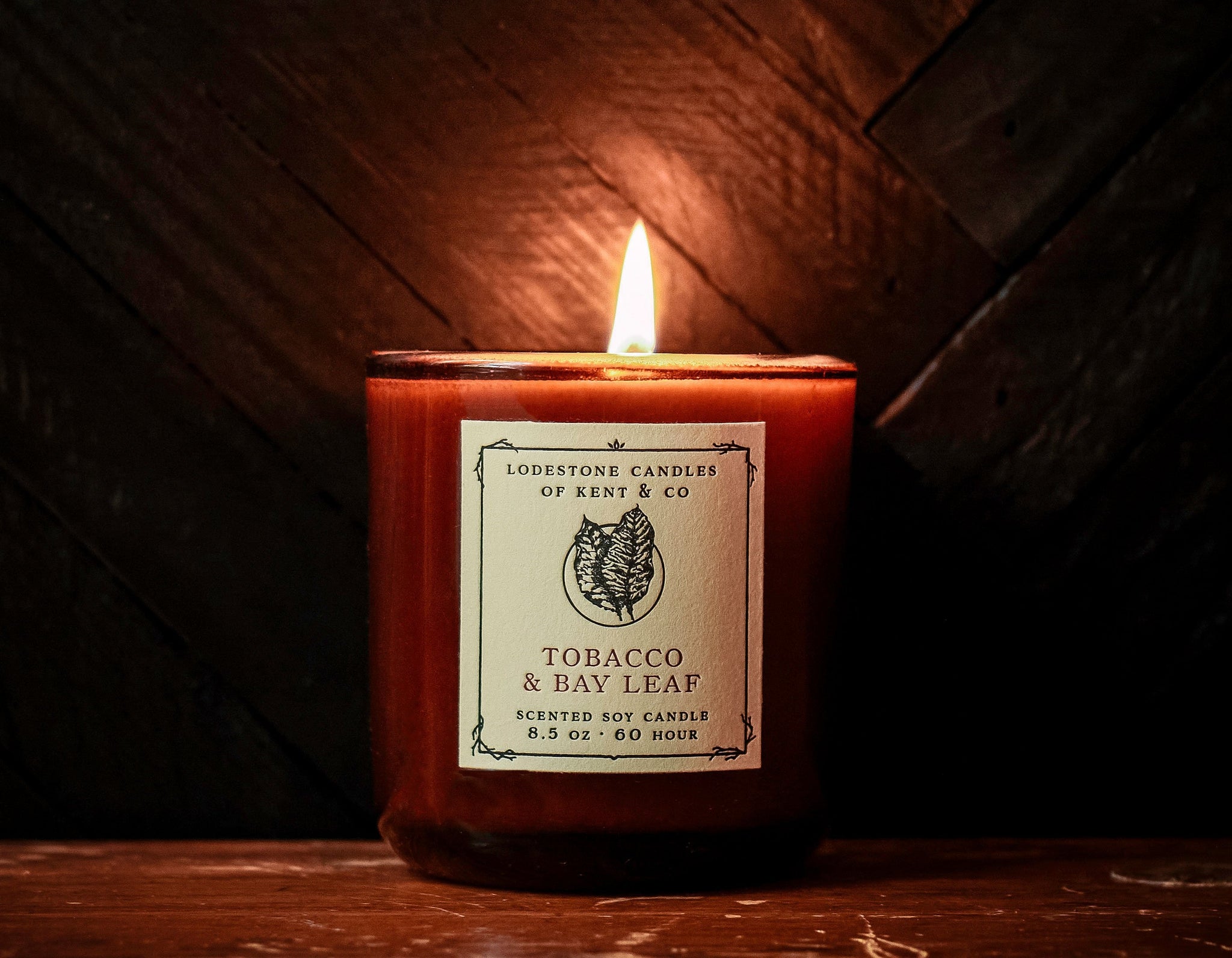 Lodestone Candles Tobacco & Bay Leaf candle with citrus and sandalwood.