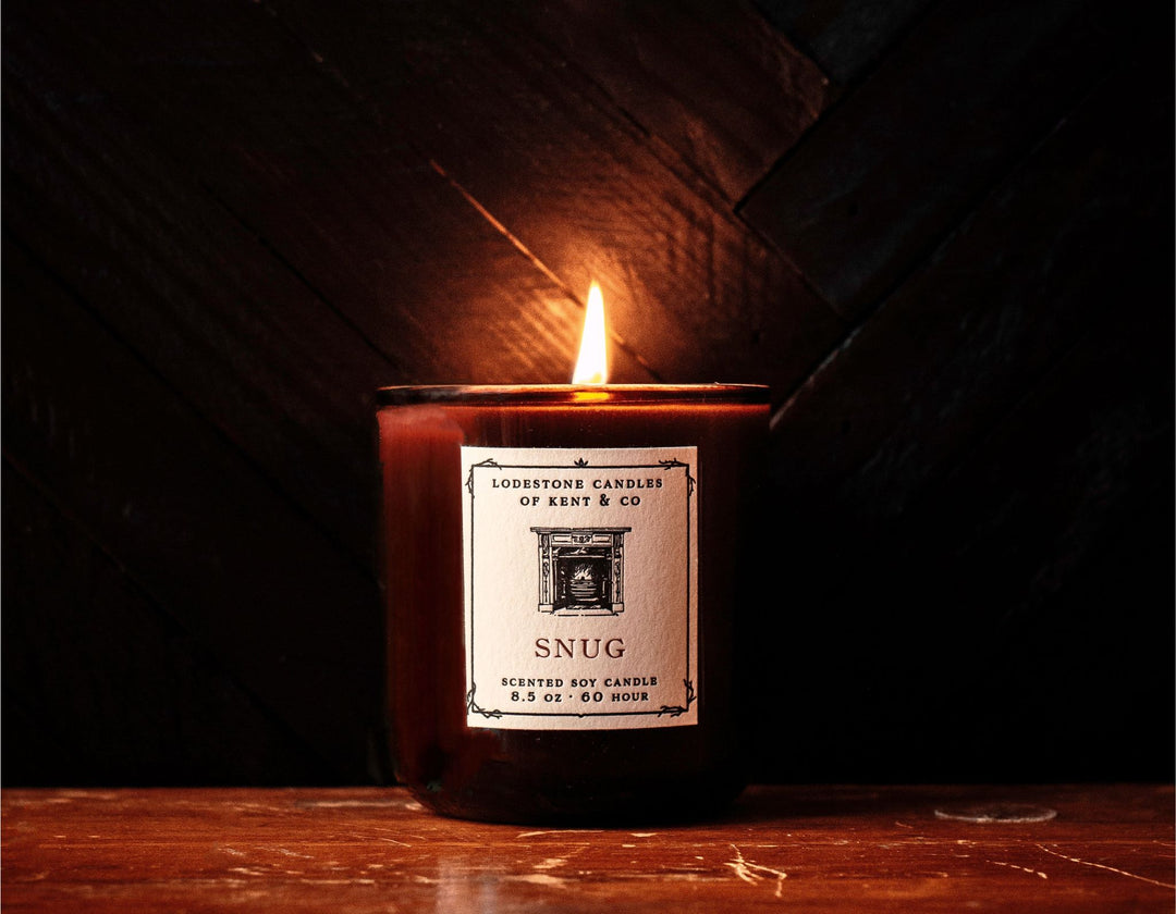 Lodestone Candles Snug candle with cedar, vetiver, and dark amber.