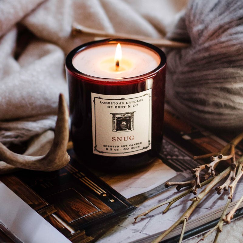Lodestone Candles Snug candle with cedar, vetiver, and dark amber.